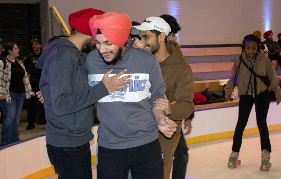 A group of students skate around the SLC
