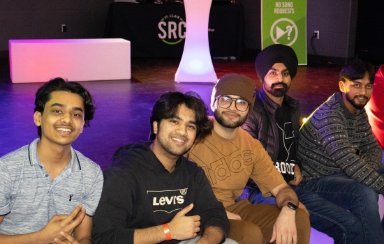 A group of students smile and pose for the camera