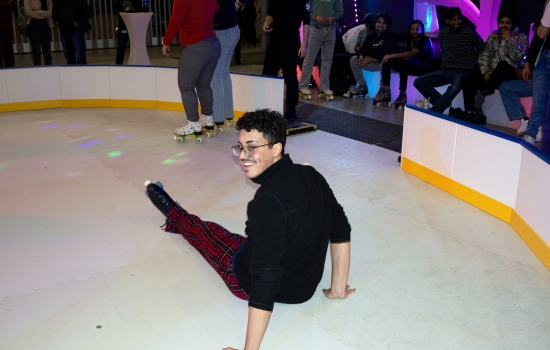 A student falls on the rink