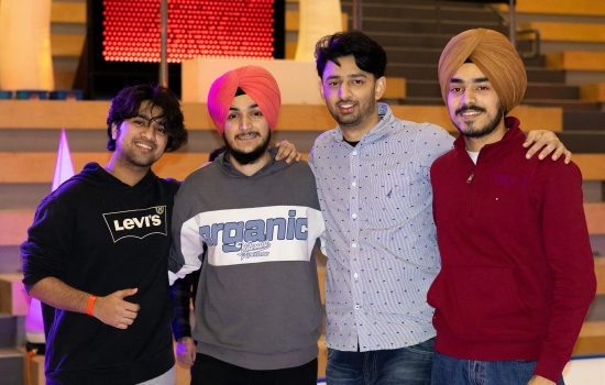 A group of students smile and pose for the camera