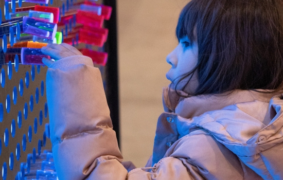 A child plays with the giant lite brite