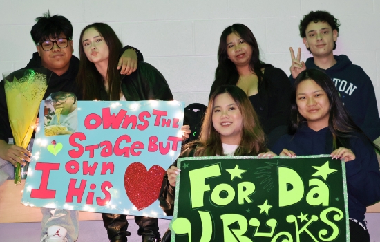 Fans support their favourite contestant with homemade signs and flowers
