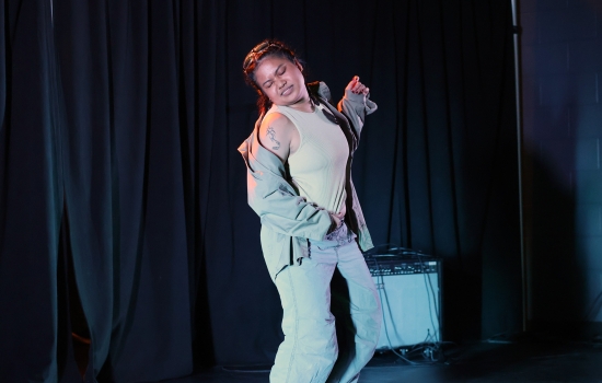 A contestant dances on the SLC stage