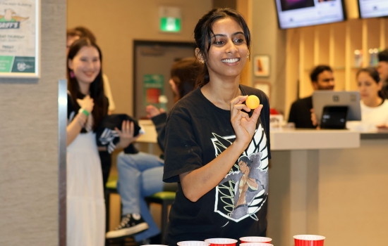 A student gets ready to take their shot in lemonade pong