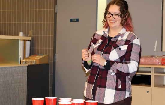 A student smiles while playing lemonade pong
