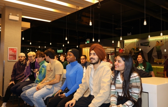 A row of students sit and watch UpDating