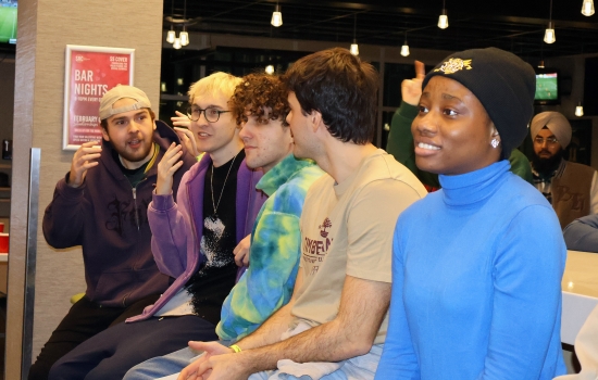 A row of students sit and watch UpDating