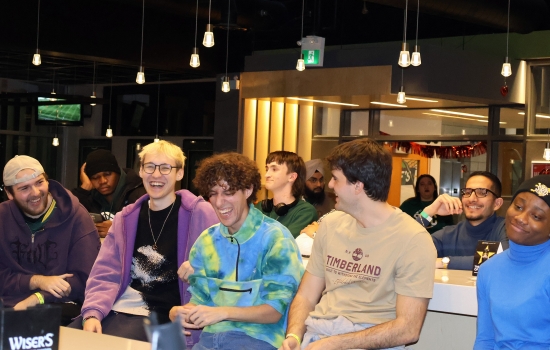 A row of students sit and watch UpDating