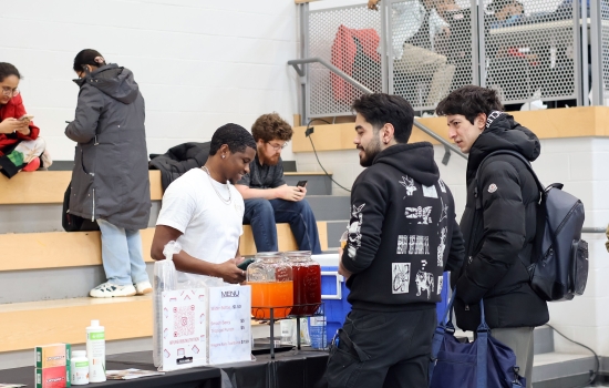 Students stop by the Pure Vibez booth for a drink