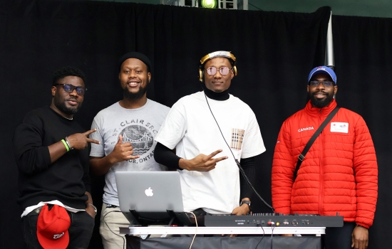 The DJ and friends pose for a photo on the SLC stage
