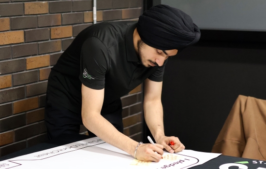 Pratham writes his reason for not cheating on the pledge poster