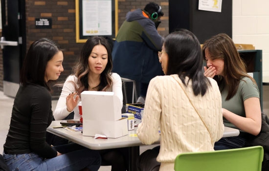 A group of four students play Telestrations