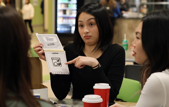 A student takes their turn at Telestrations