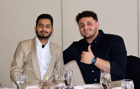 Rishi and Ali pose for the camera at their seats
