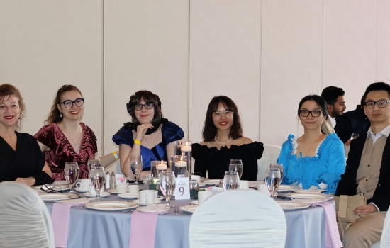A table of guests pose for the camera