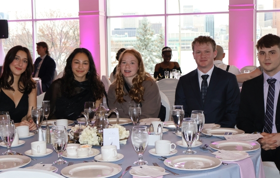A table of guests pose for the camera