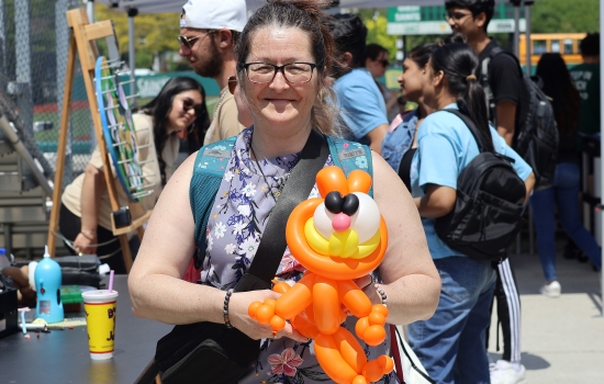 A student shows off her Garfield balloon animal