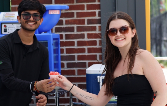 Souravdeep serves a student a snowcone