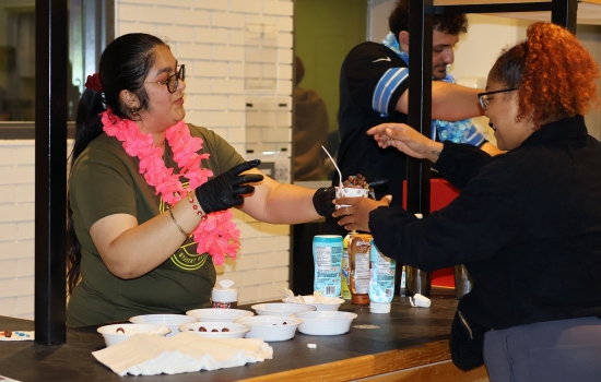 Nanza hands ice cream to a student