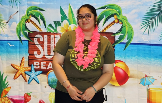 Nanza poses in front of the backdrop