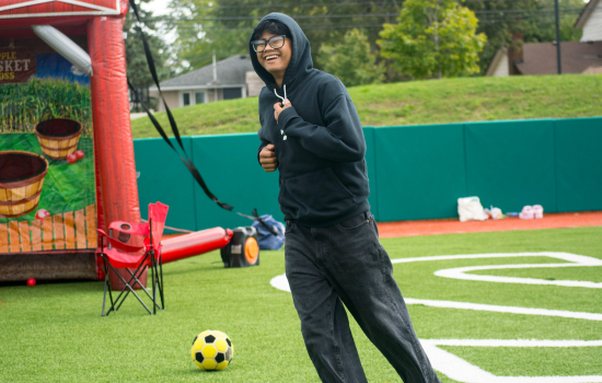 a student in action playing inflatable soccer