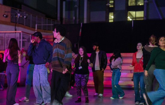 students dance in the slc