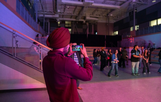Pratham takes a photo of dancers in the SLC