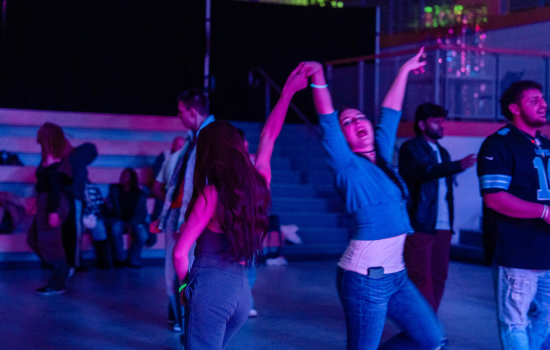 students dance in the slc