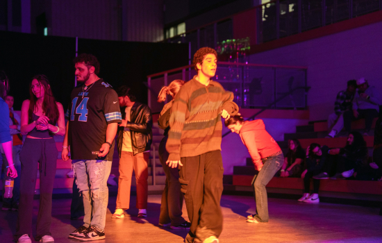 students dance in the slc