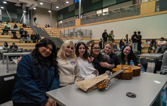 Audience members and board members smile for the camera