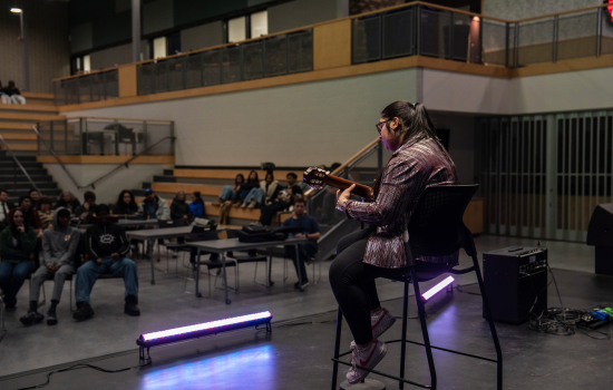 Nanza performs with a guitar