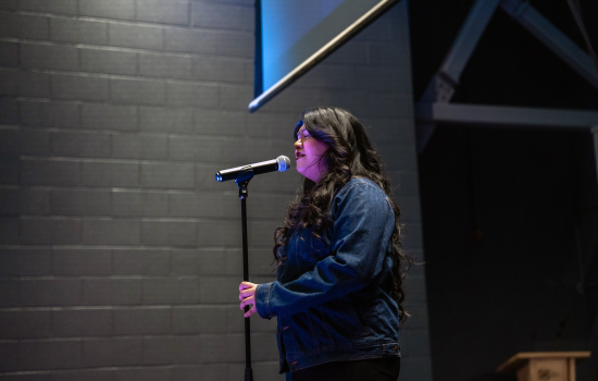 Contestant sings into the microphone