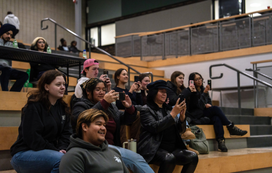 Audience members record the performance