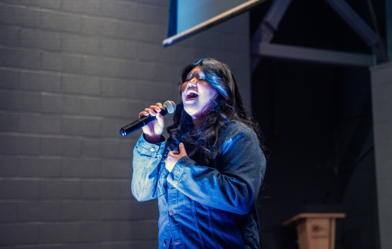 Contestant sings into the microphone