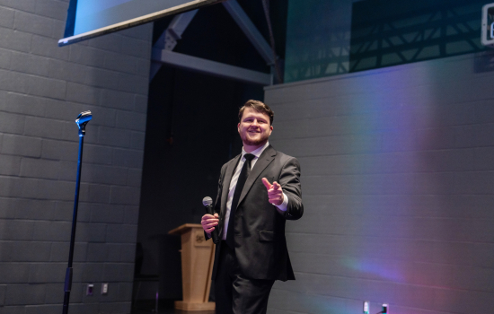 A contestant in a suit takes the stage