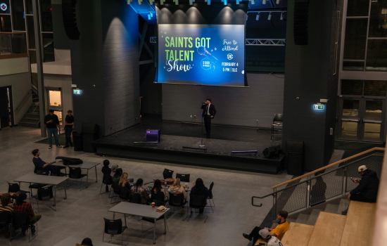 A contestant in a suit takes the stage
