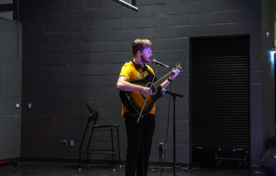 Saints Got Talent contestant performs with a guitar