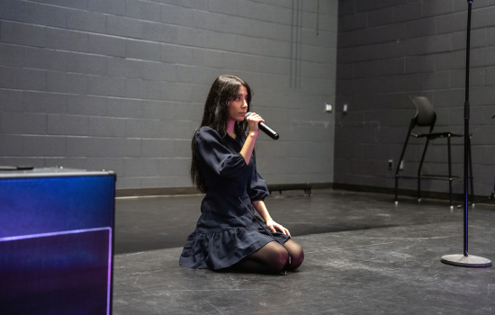 Contestant sings into the microphone