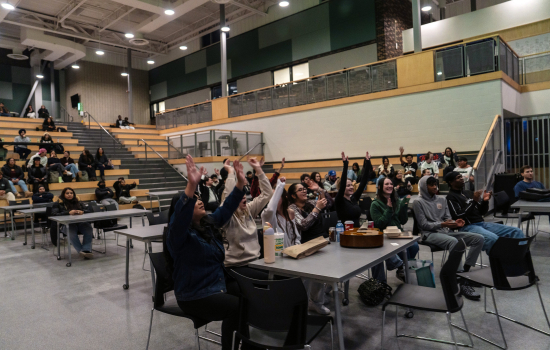 The audience puts their hands up