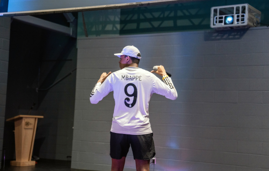 A contestant shows the back of his shirt reading Mbappe