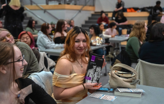 A student shows off their prize selection