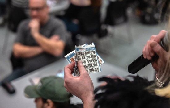 The host checks a winning bingo card