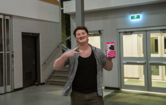 A student shows off their prize selection