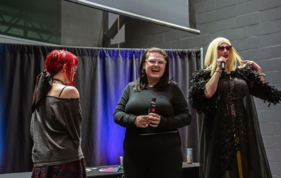 Students laugh on stage with the host