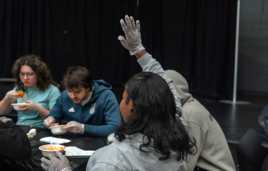 First contestant to finish the noodle challenge raises their hand