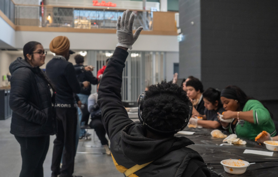 Another contestant to finish the noodle challenge raises their hand