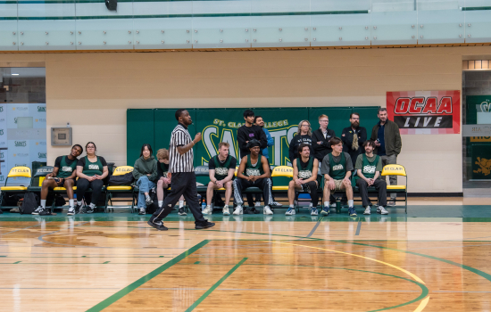 Team SRC players watch from the sidelines