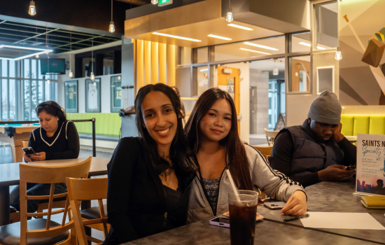 Two students pose for a photo in Griff's