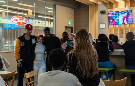 Behind the scenes of students posing for a photo