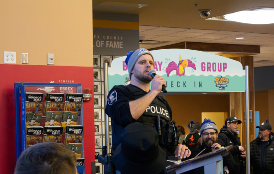 A Windsor police officer addresses the crowd